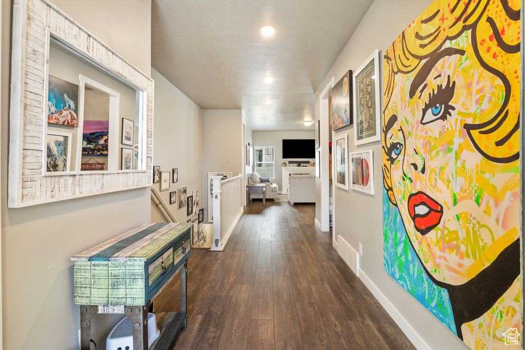 Hall featuring dark wood finished floors and recessed lighting