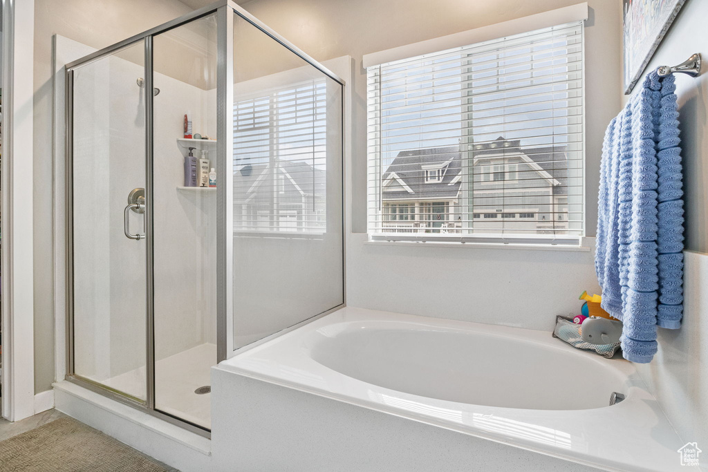Full bath featuring a bath and a stall shower