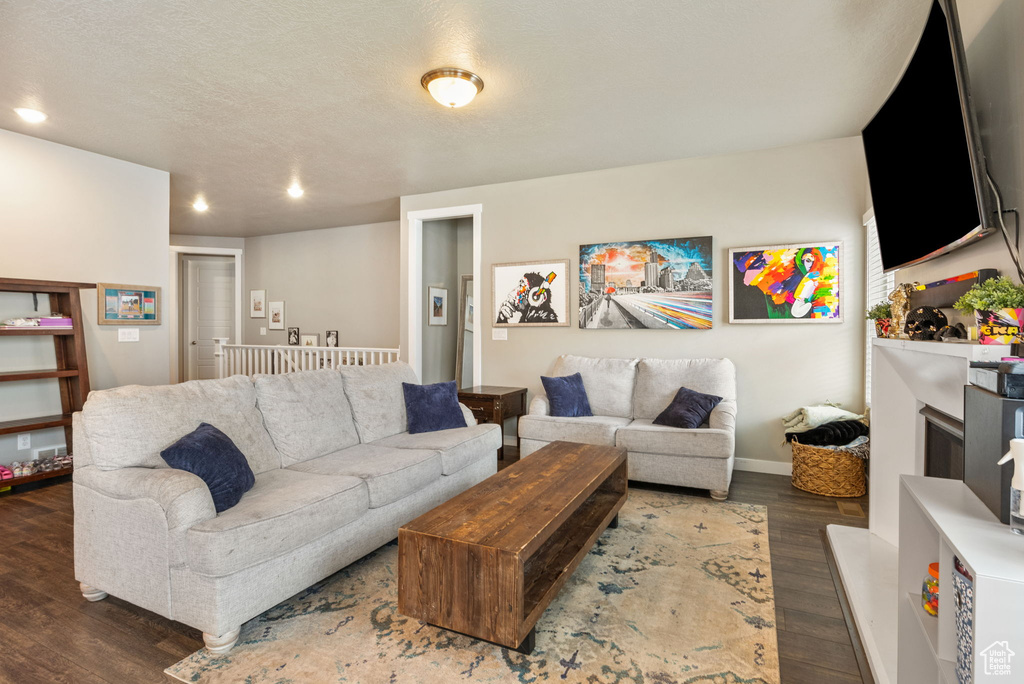 Living area featuring wood finished floors, recessed lighting, and a textured ceiling