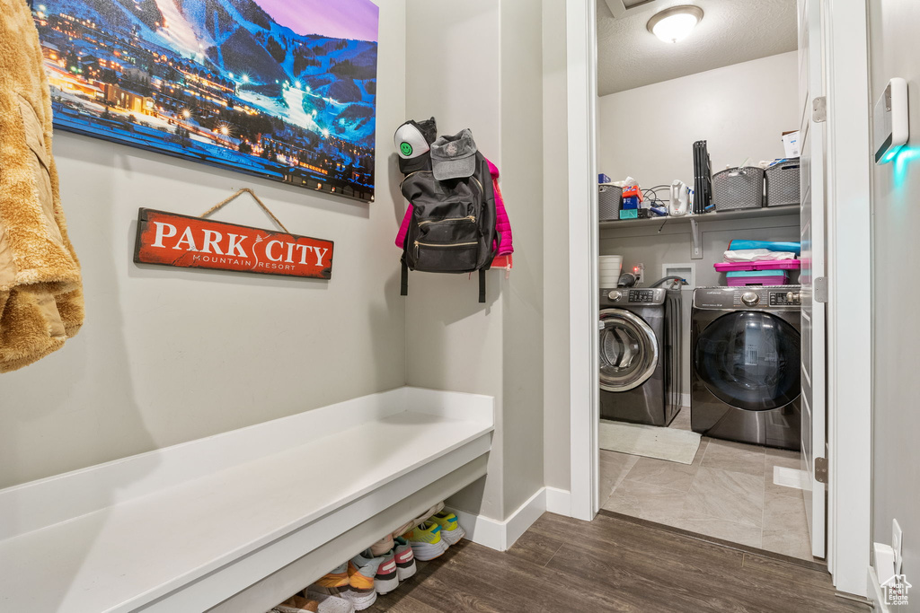 Laundry area with washing machine and clothes dryer and dark wood-style floors