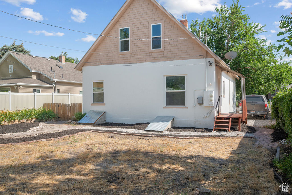 Rear view of property featuring a chimney
