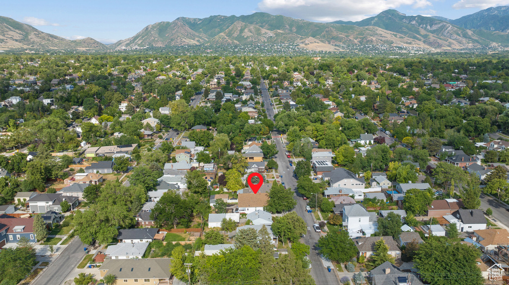 Aerial view of property and surrounding area featuring mountains