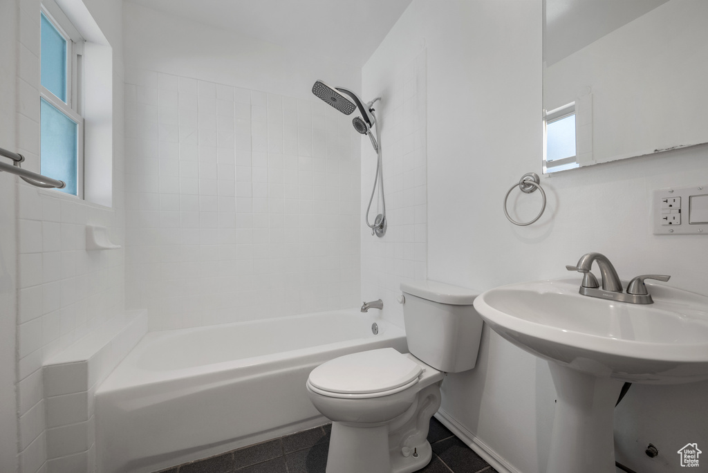 Bathroom featuring toilet and shower / bath combination