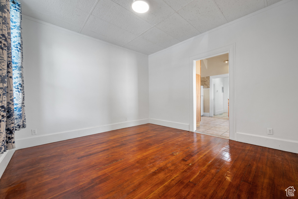 Unfurnished room featuring ornamental molding and hardwood / wood-style floors