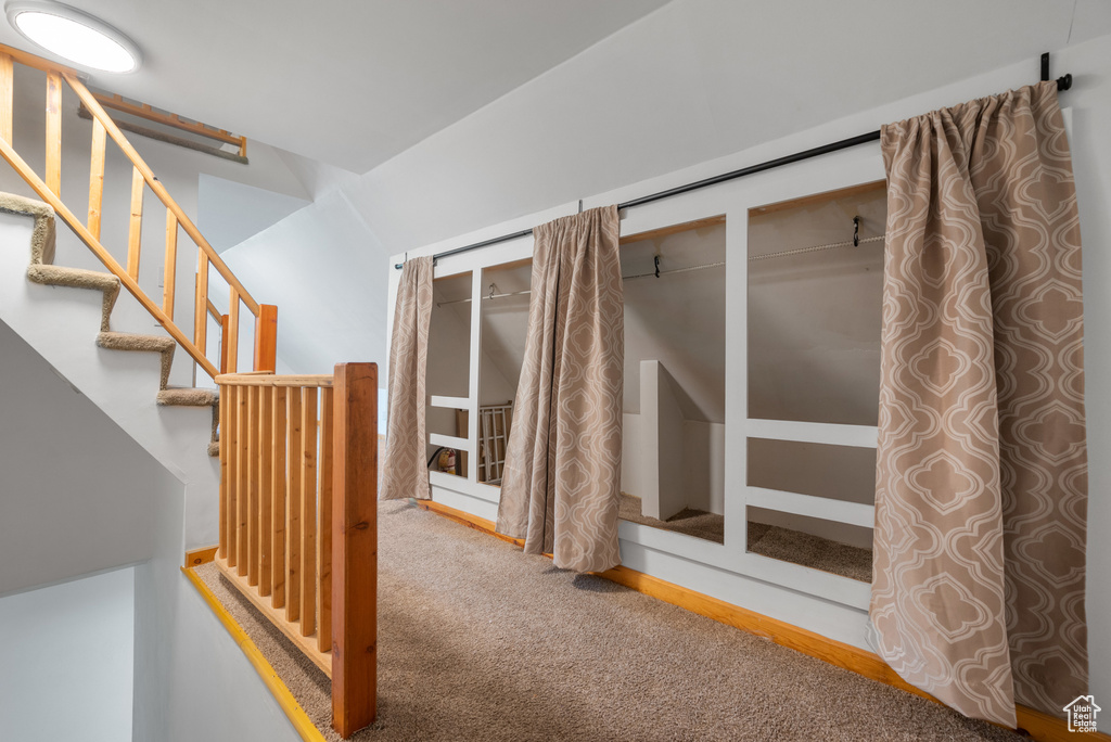 Hall featuring carpet flooring