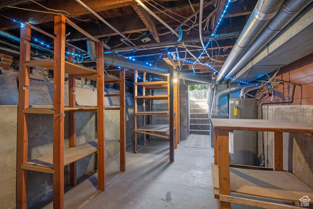 Below grade area featuring water heater