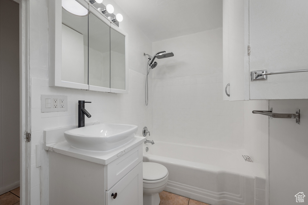Full bath with tile patterned flooring, vanity, and shower / tub combination