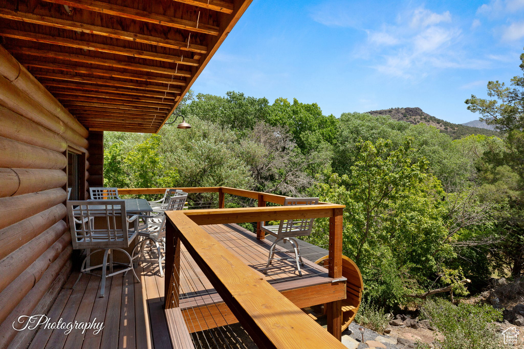 Wooden terrace featuring a mountain view and a forest view