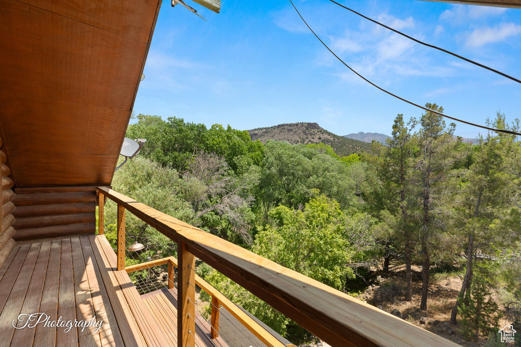 Balcony featuring a mountain view and a forest view