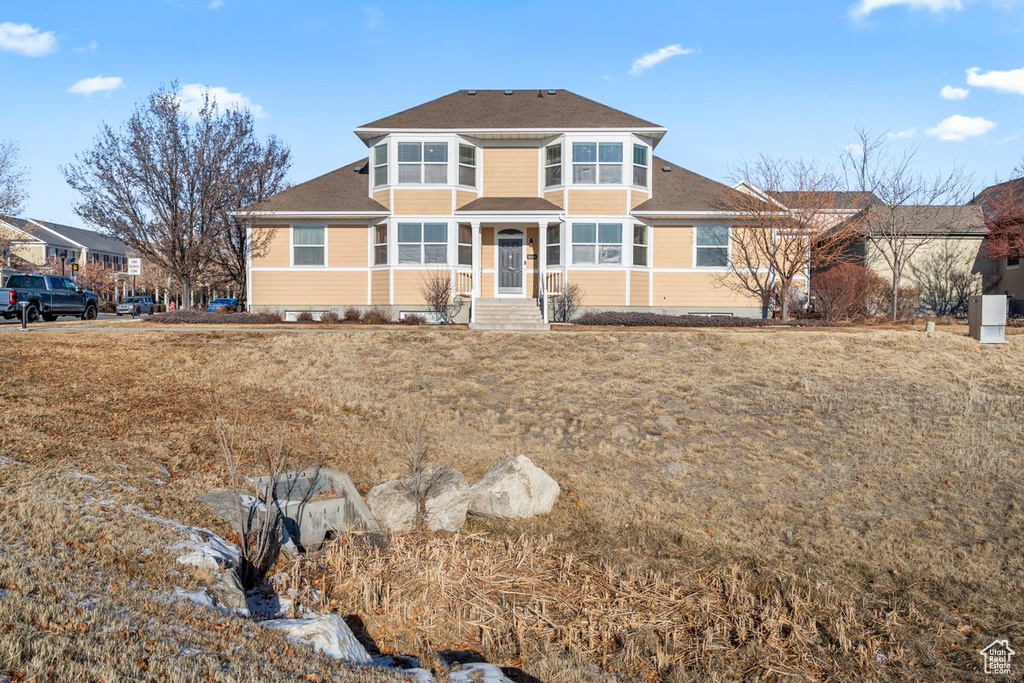 View of front of property featuring a shingled roof