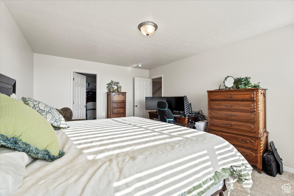 Bedroom featuring carpet floors and baseboards