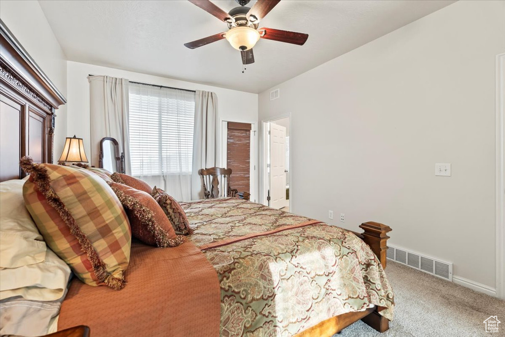 Carpeted bedroom featuring baseboards and ceiling fan