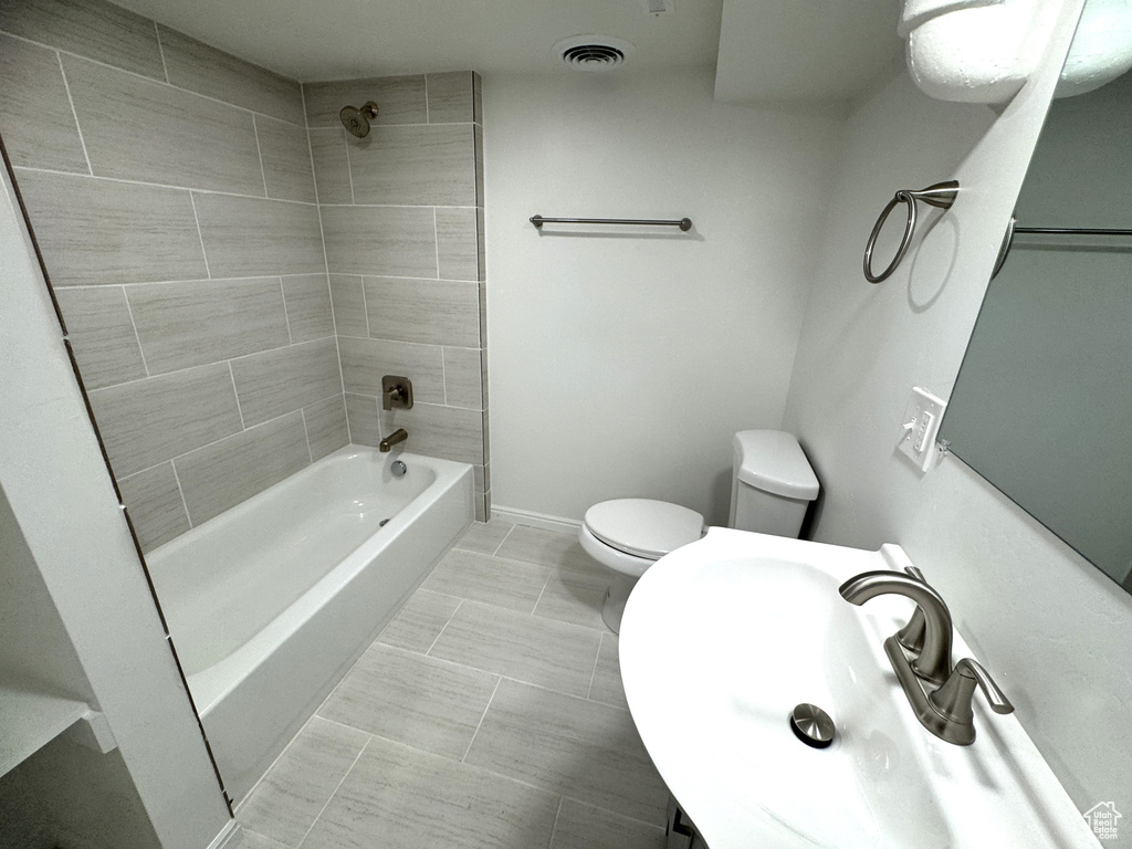 Bathroom featuring bathtub / shower combination and tile patterned flooring
