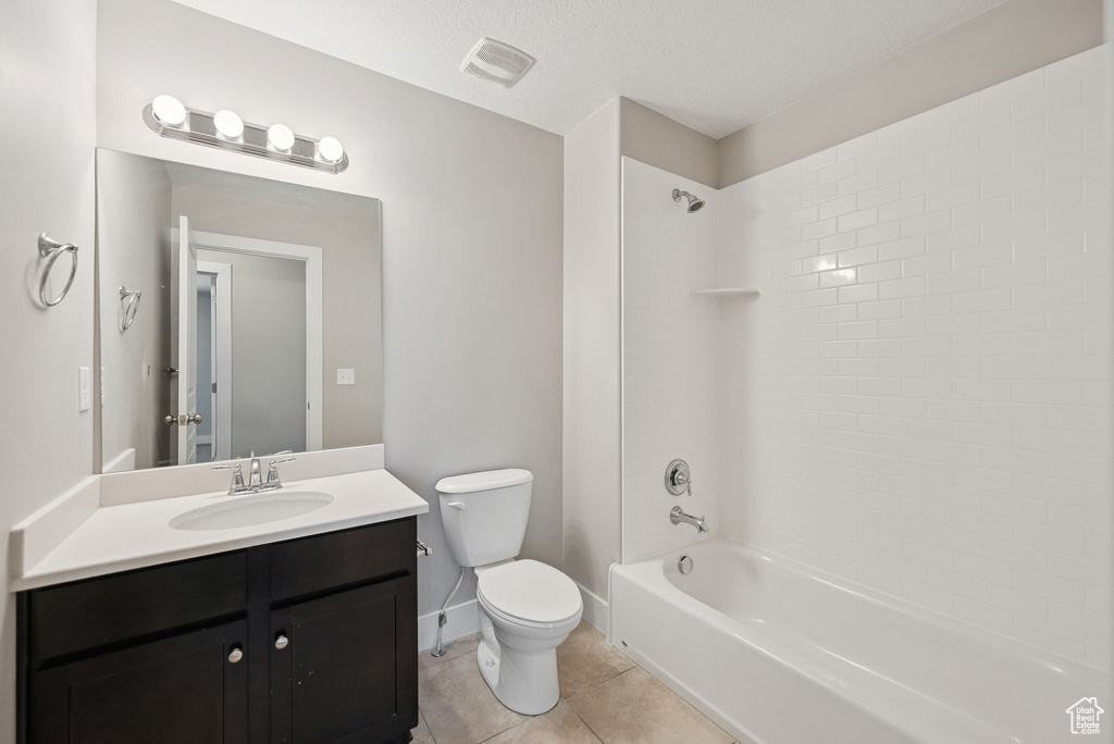 Full bathroom featuring vanity, shower / tub combination, and tile patterned floors