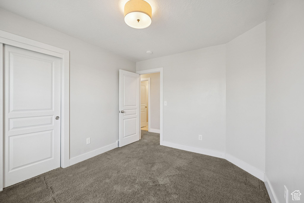 Unfurnished bedroom featuring carpet floors and a closet