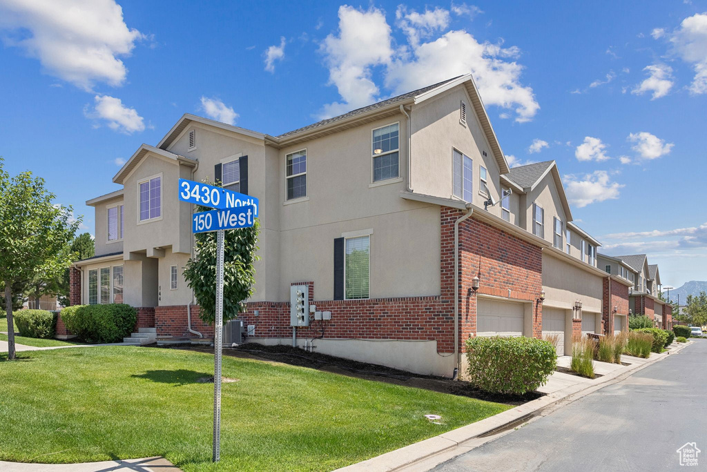 View of property with an attached garage and a residential view