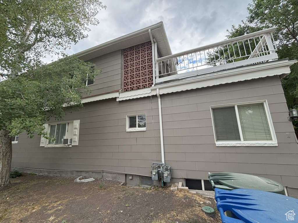 View of side of home featuring a balcony