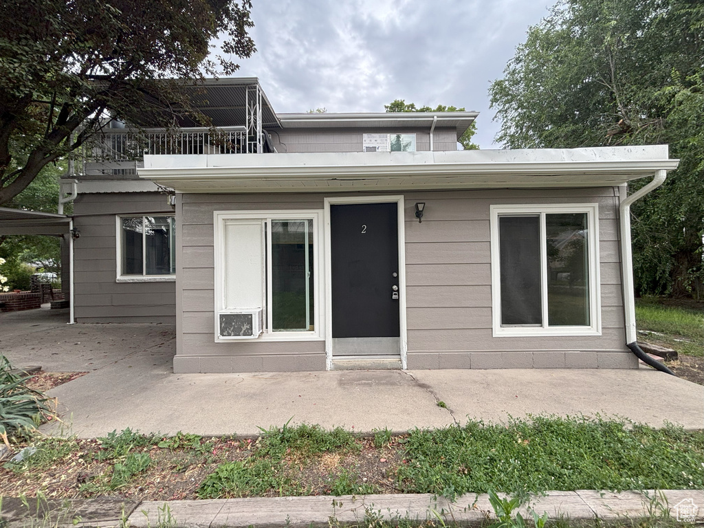 Rear view of house with a patio and a balcony
