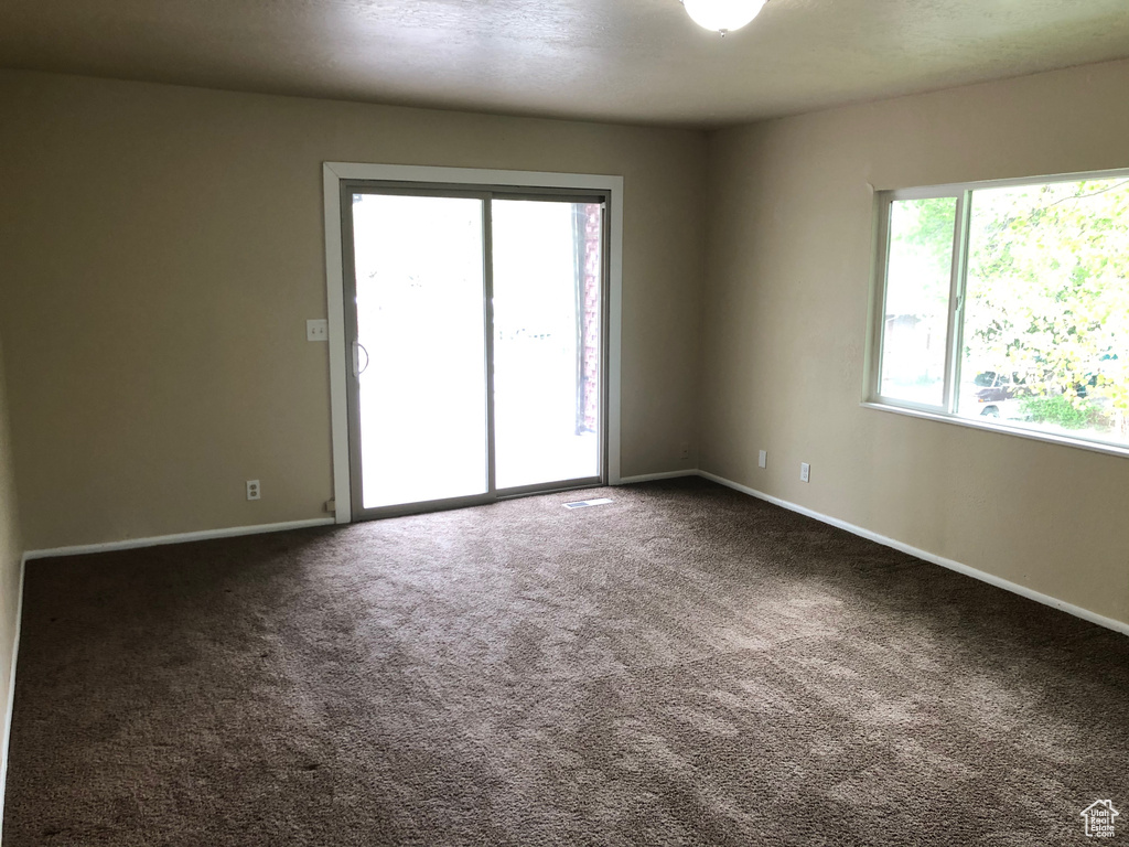 Spare room featuring baseboards and carpet flooring