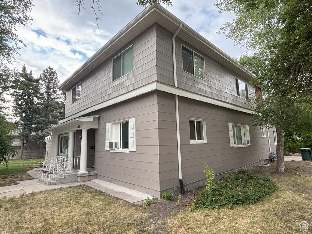 Back of property with a yard