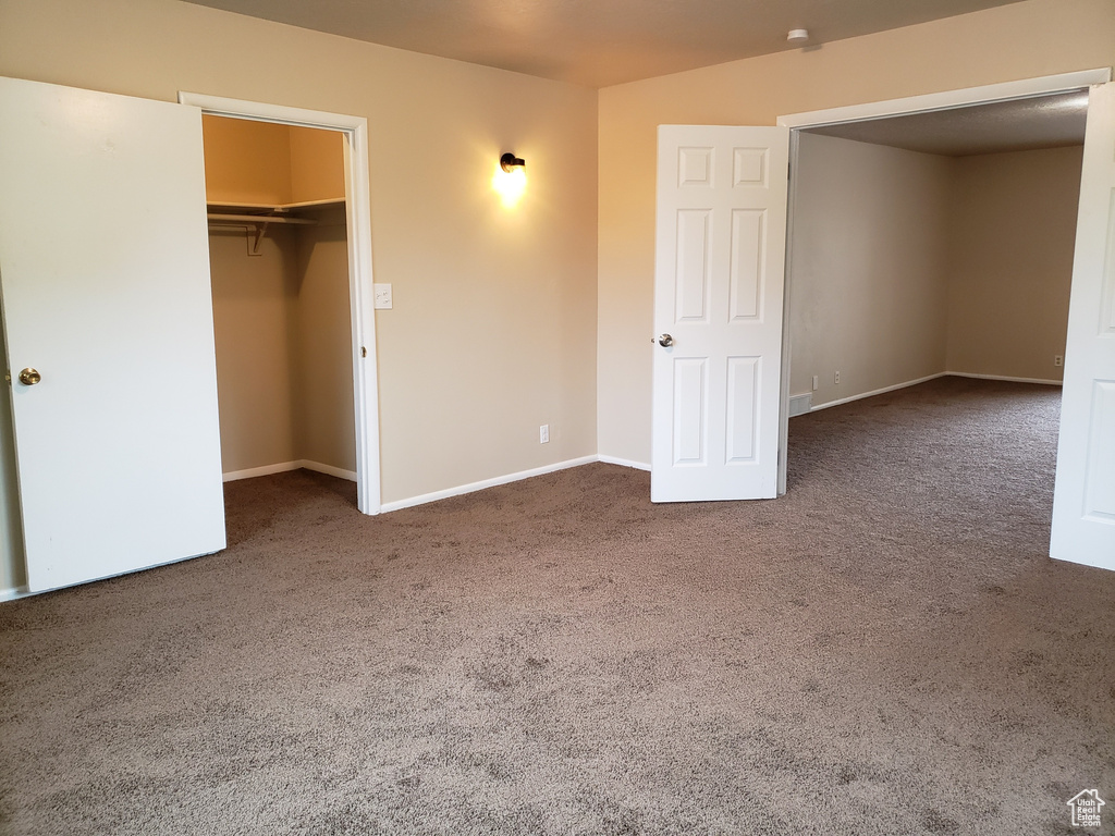 Unfurnished bedroom featuring carpet floors and a closet