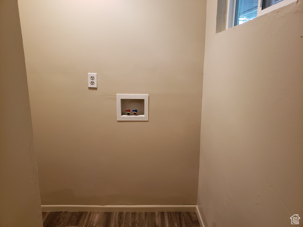 Laundry room featuring washer hookup and dark wood-style floors