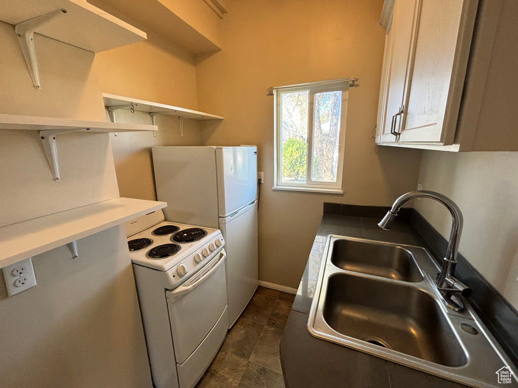Kitchen featuring electric range and open shelves