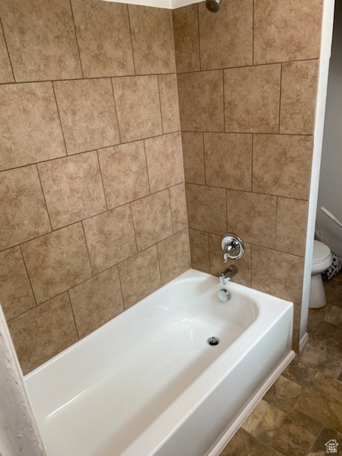 Bathroom with toilet and shower / bathtub combination