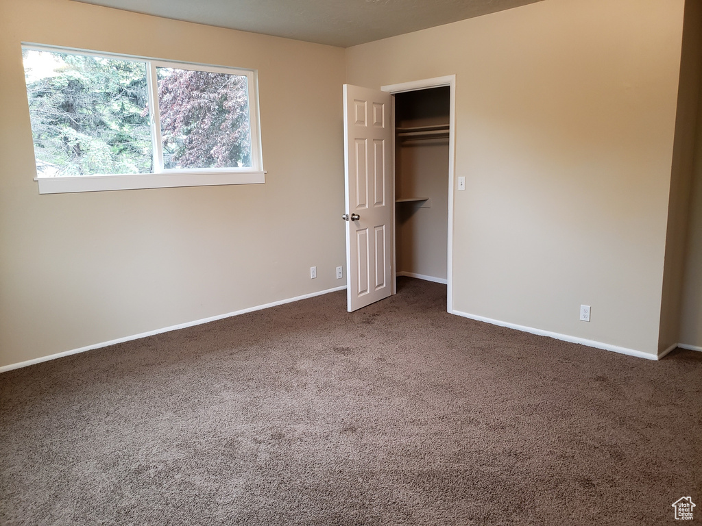 Unfurnished bedroom featuring carpet floors and a closet