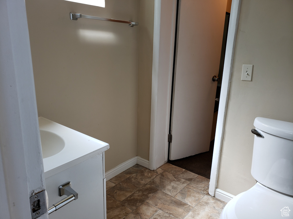 Bathroom with vanity and stone finish floors