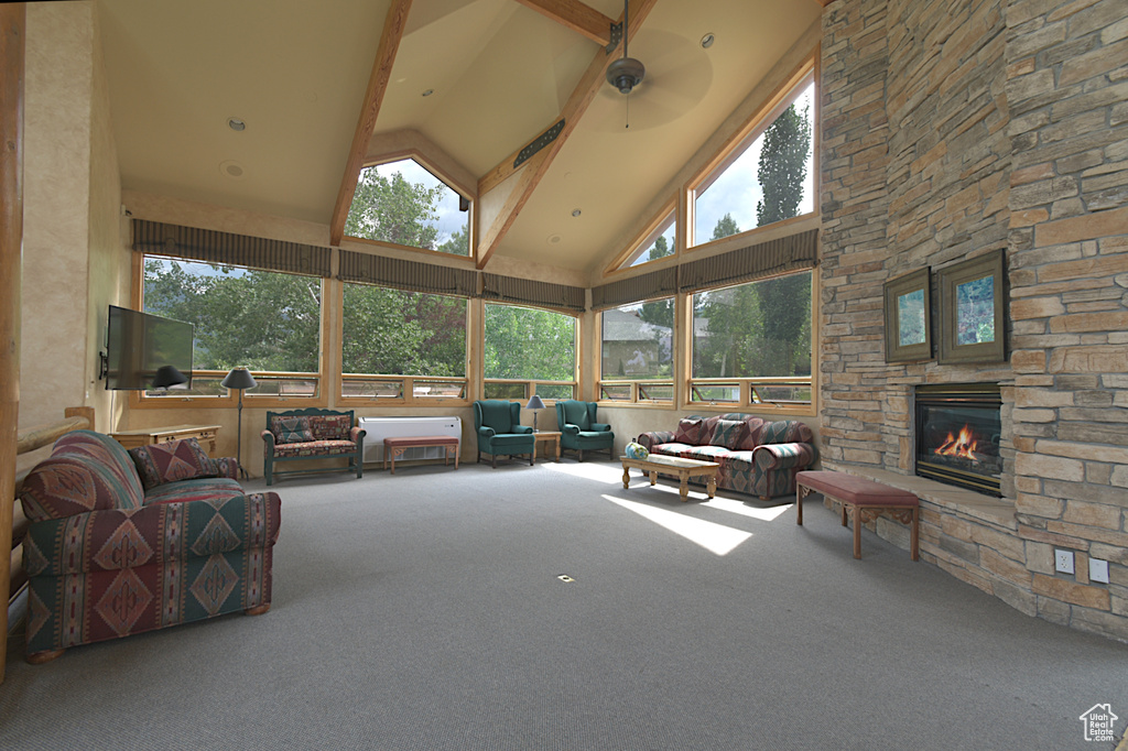 Sunroom with high vaulted ceiling, carpet floors, and beamed ceiling