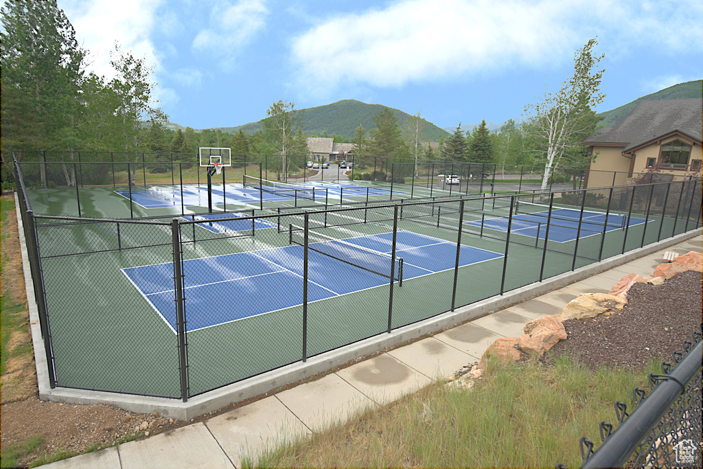 View of tennis court featuring a mountain view and community basketball court