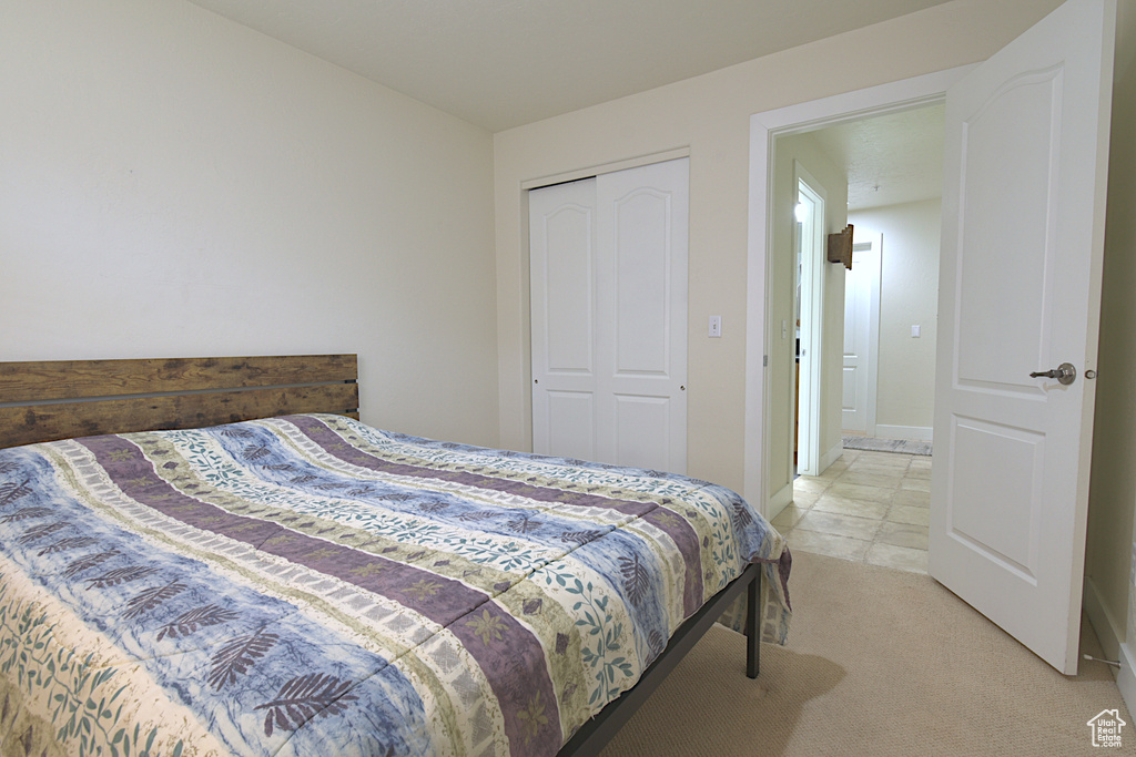 Bedroom featuring a closet and light carpet
