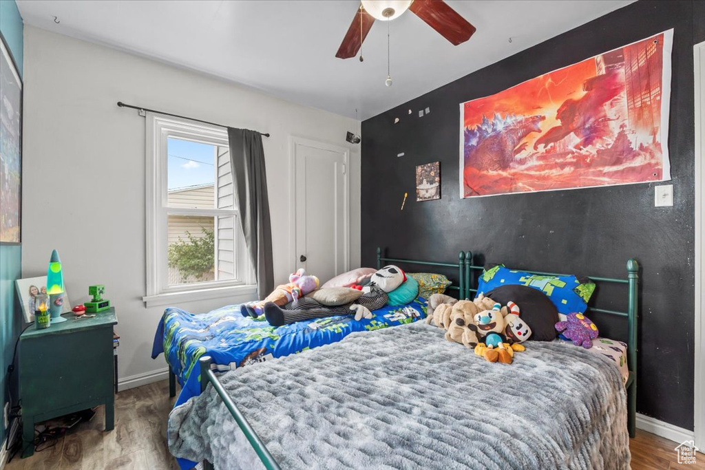 Bedroom with wood finished floors and ceiling fan