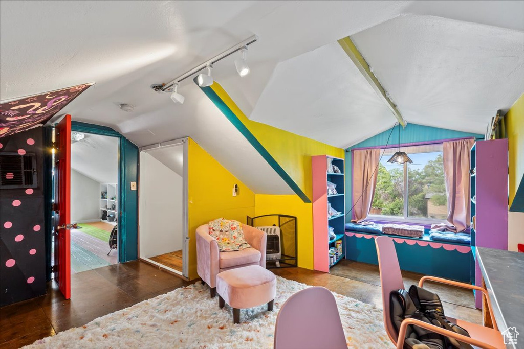 Recreation room with lofted ceiling, rail lighting, and wood finished floors