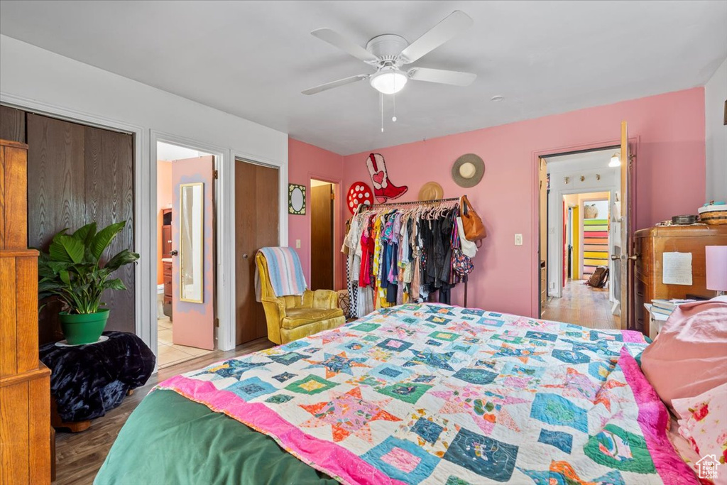 Bedroom with ceiling fan and wood finished floors