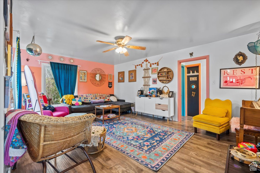 Living room featuring ceiling fan and wood finished floors