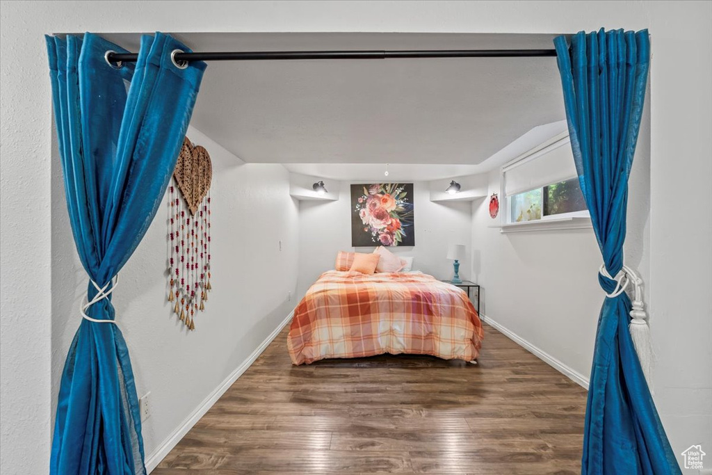 Bedroom featuring wood finished floors and baseboards