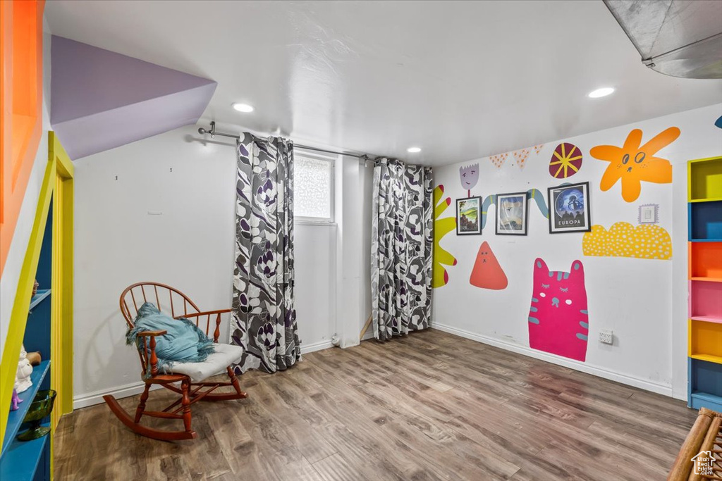 Living area with wood finished floors and recessed lighting