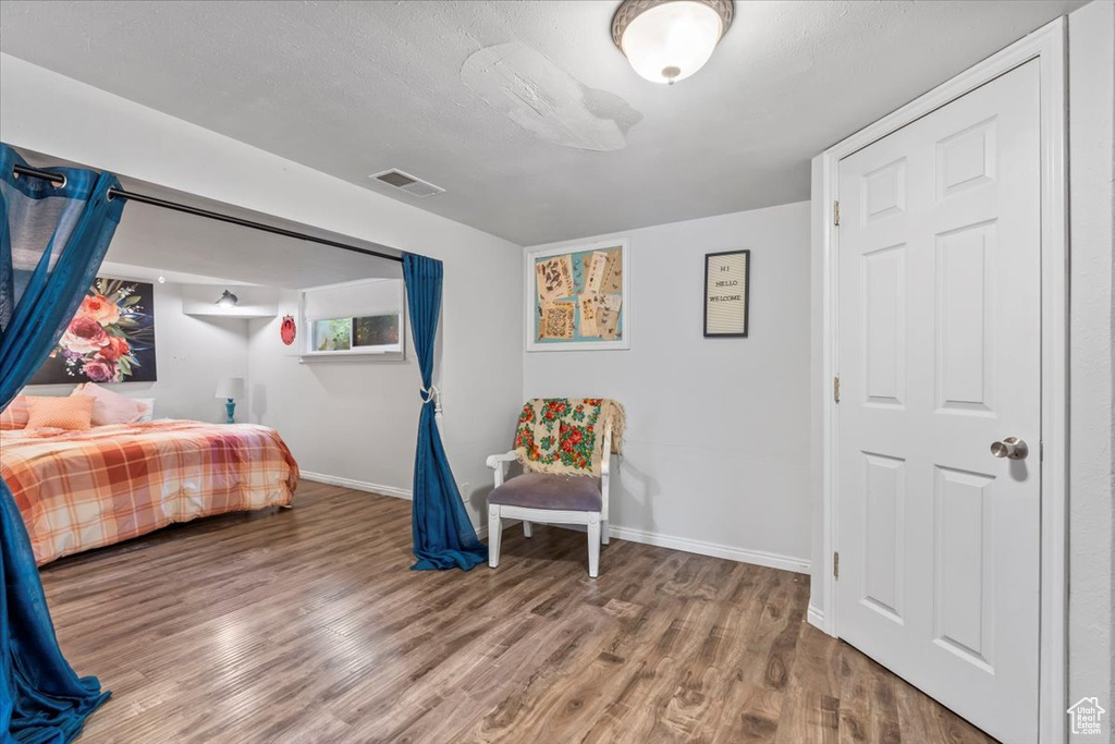 Bedroom featuring wood finished floors and baseboards
