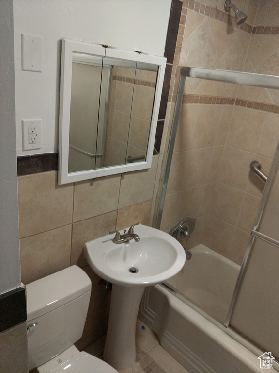 Full bath featuring bathtub / shower combination and tile walls