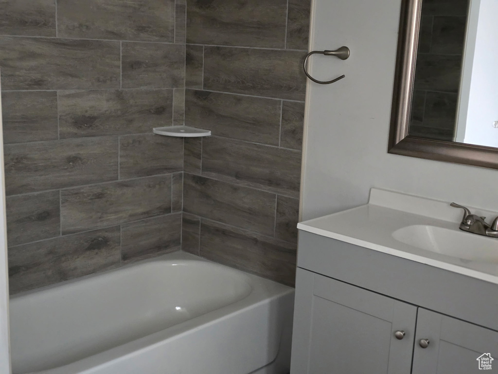 Bathroom with vanity and bathtub / shower combination