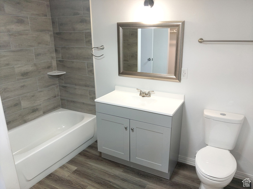 Full bathroom featuring vanity, wood finished floors, and shower / washtub combination