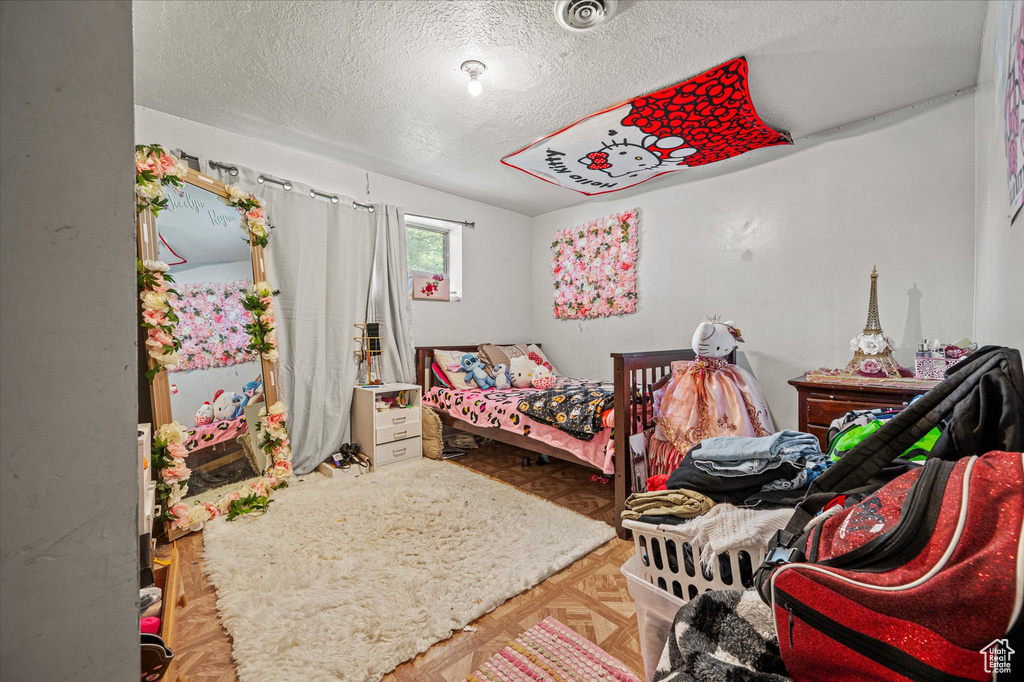Bedroom with a textured ceiling