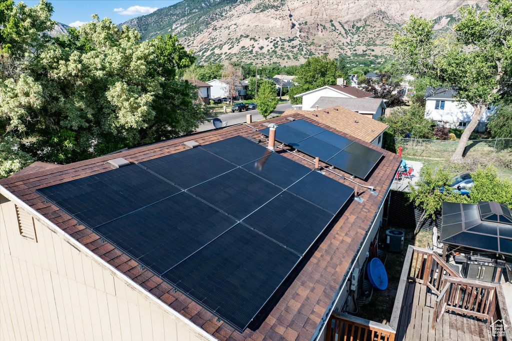 View of tennis court with a mountain view and a residential view