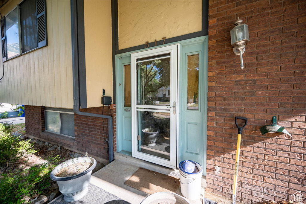 Property entrance featuring brick siding