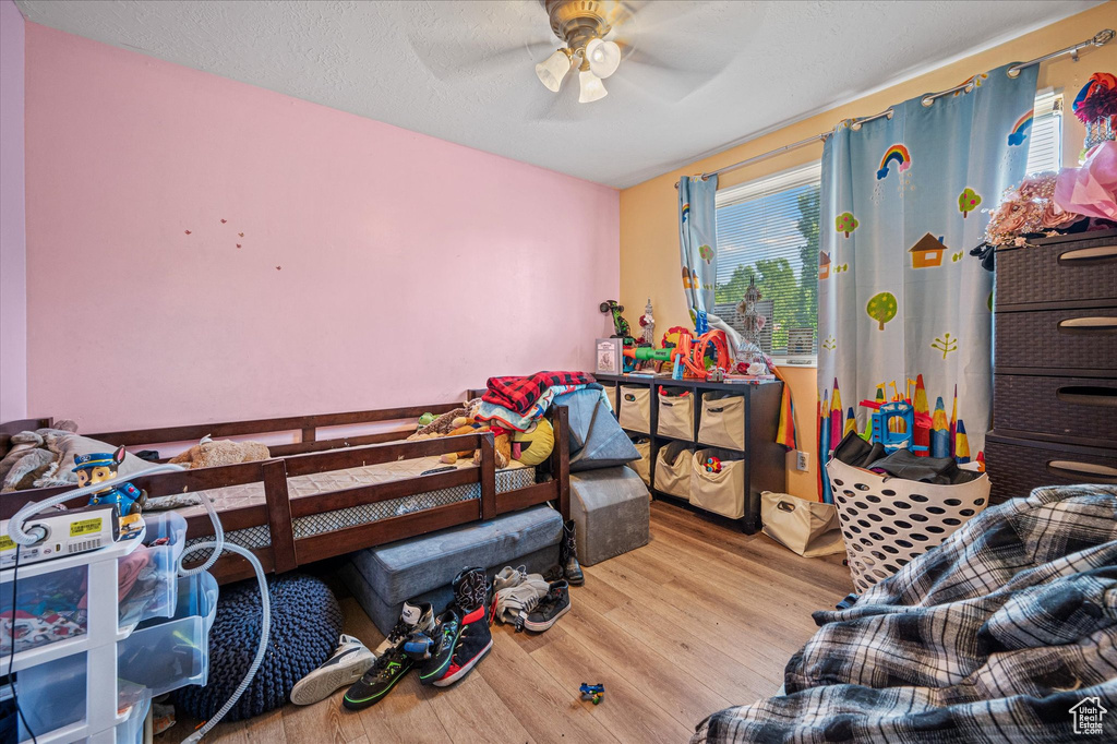 Bedroom featuring wood finished floors and ceiling fan