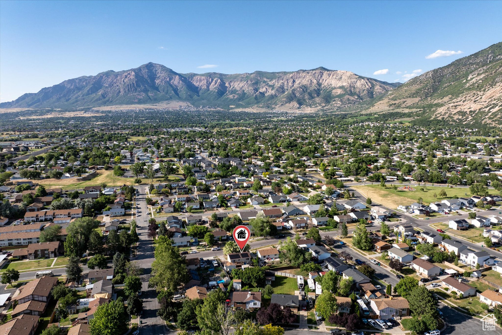 View of property location featuring mountains and nearby suburban area