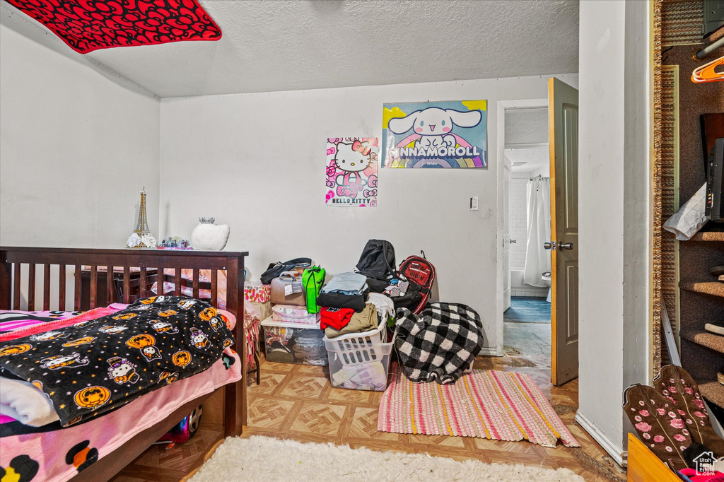 Bedroom with a textured ceiling