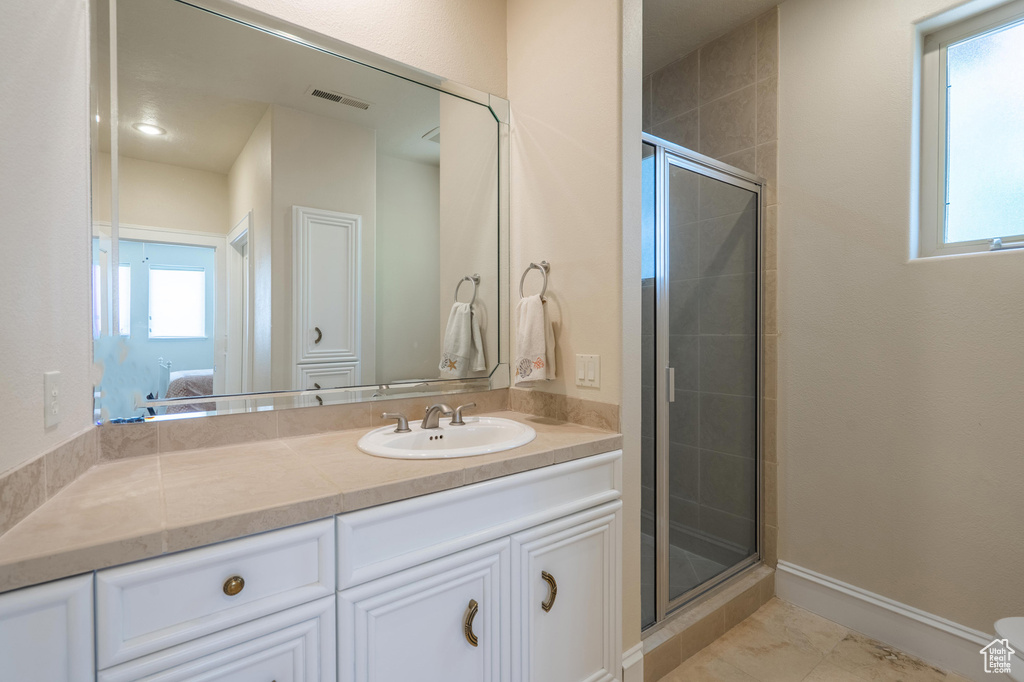 Full bath with connected bathroom, a shower stall, and vanity